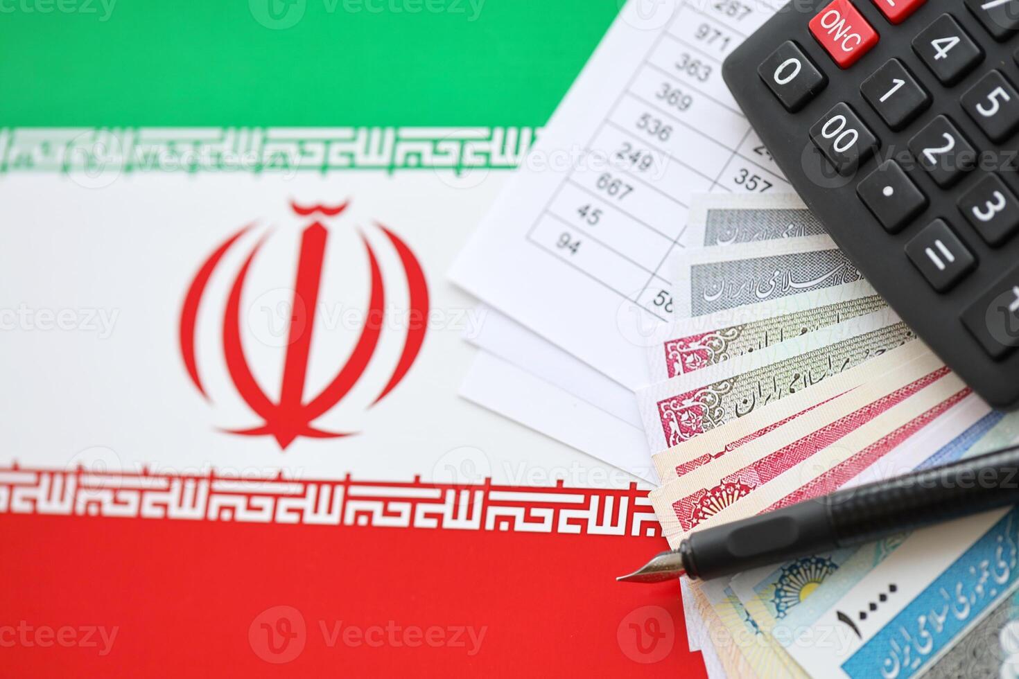 Iranian business calculations on table with iranian money and pen photo