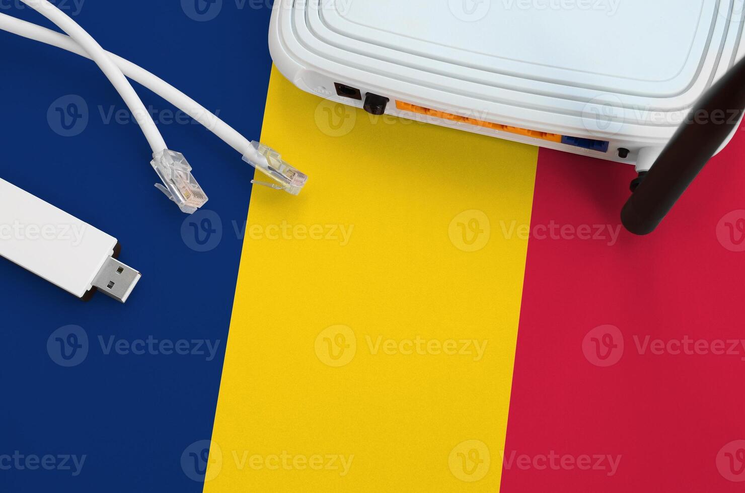 Chad flag depicted on table with internet rj45 cable, wireless usb wifi adapter and router. Internet connection concept photo