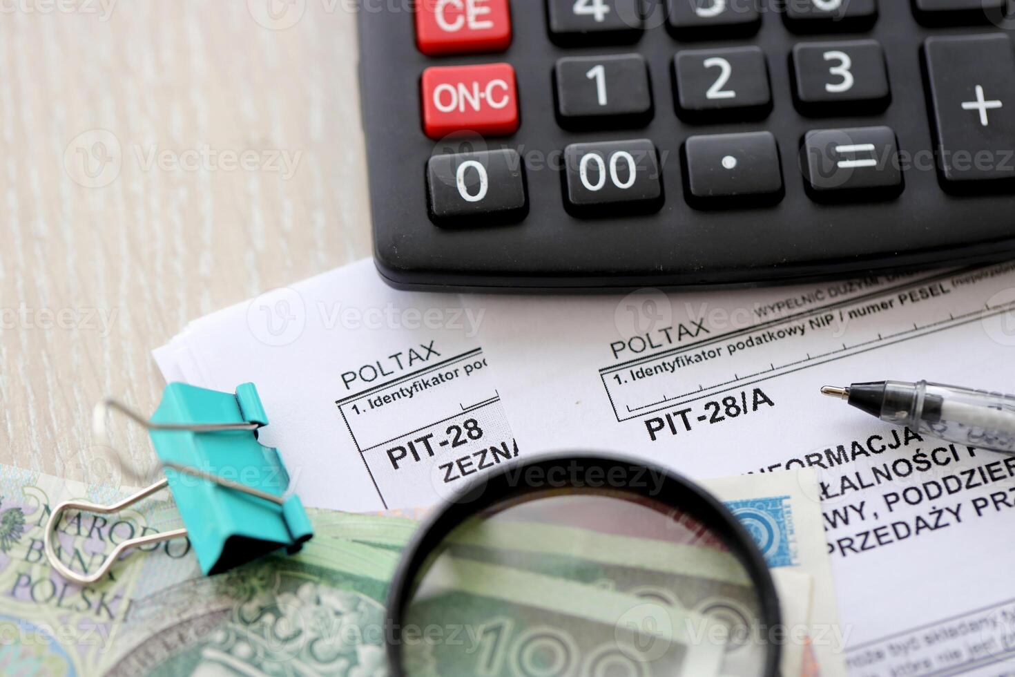 Information of income of inherited enterprise PIT28 and PIT-28A tax forms on accountant table with pen and polish zloty money bills photo