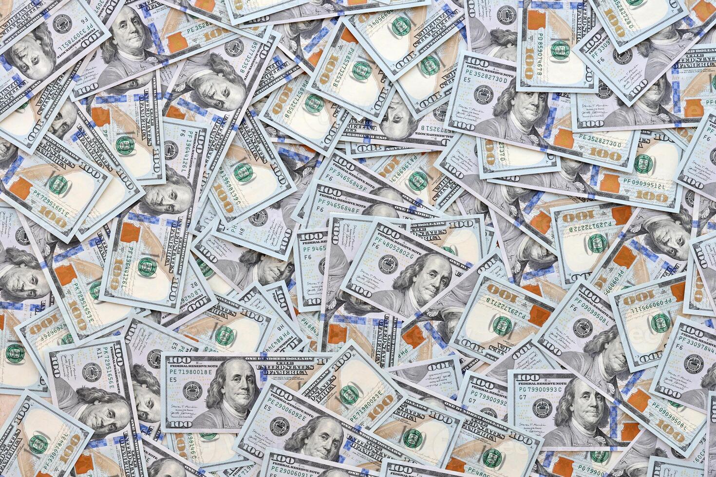 Very big amount of US hundred dollar bills. Huge quantity of united states currency notes on flat table photo