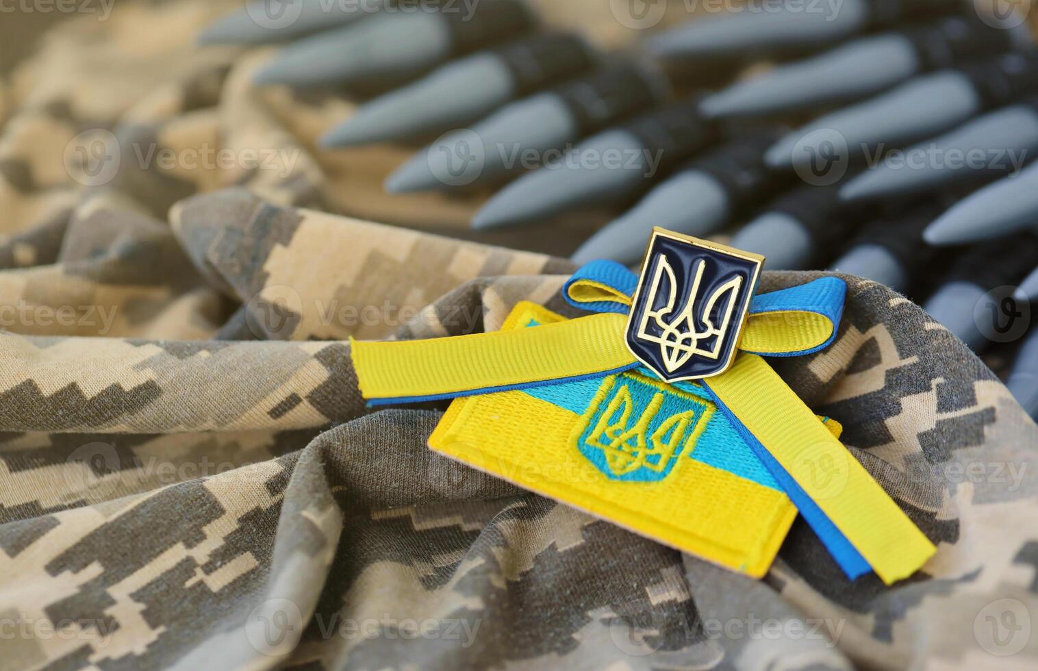 Ukrainian symbol and a machine gun belt on the camouflage uniform of a Ukrainian soldier. The Concept of war in Ukraine, patriotism and protecting your country from occupiers photo