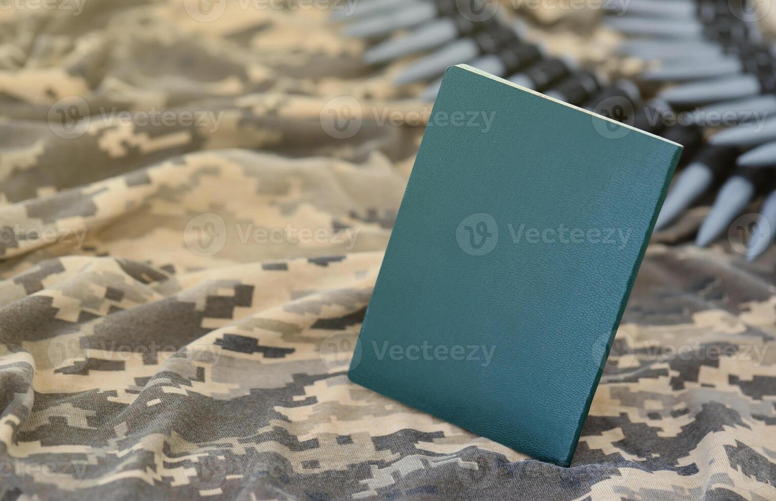 Ukrainian military ID on fabric with texture of pixeled camouflage. Cloth with camo pattern in grey, brown and green pixel shapes with Ukrainian army personal token photo