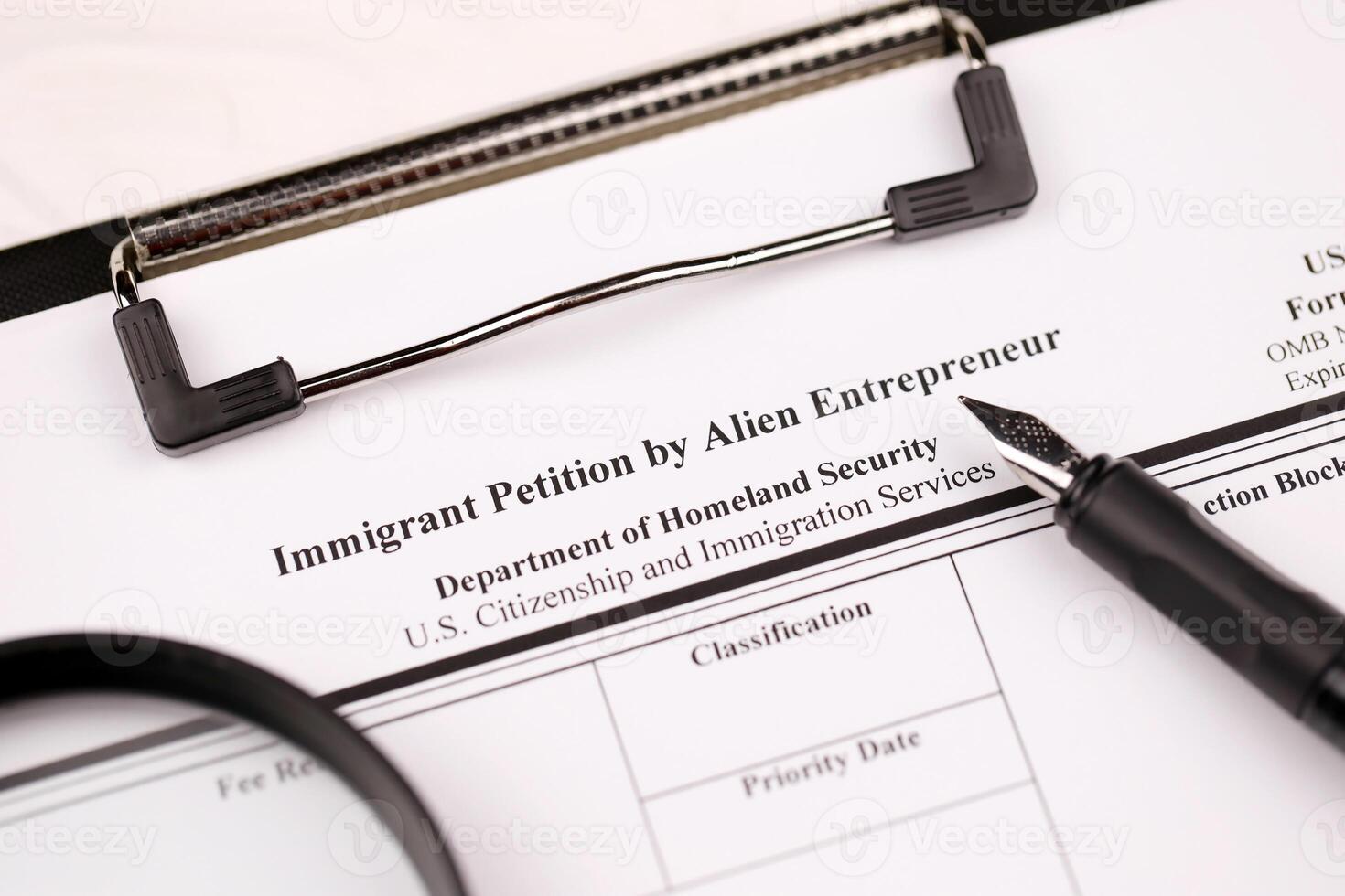 I-526 Immigrant Petition by Alien Entrepreneur blank form on A4 tablet lies on office table with pen and magnifying glass photo