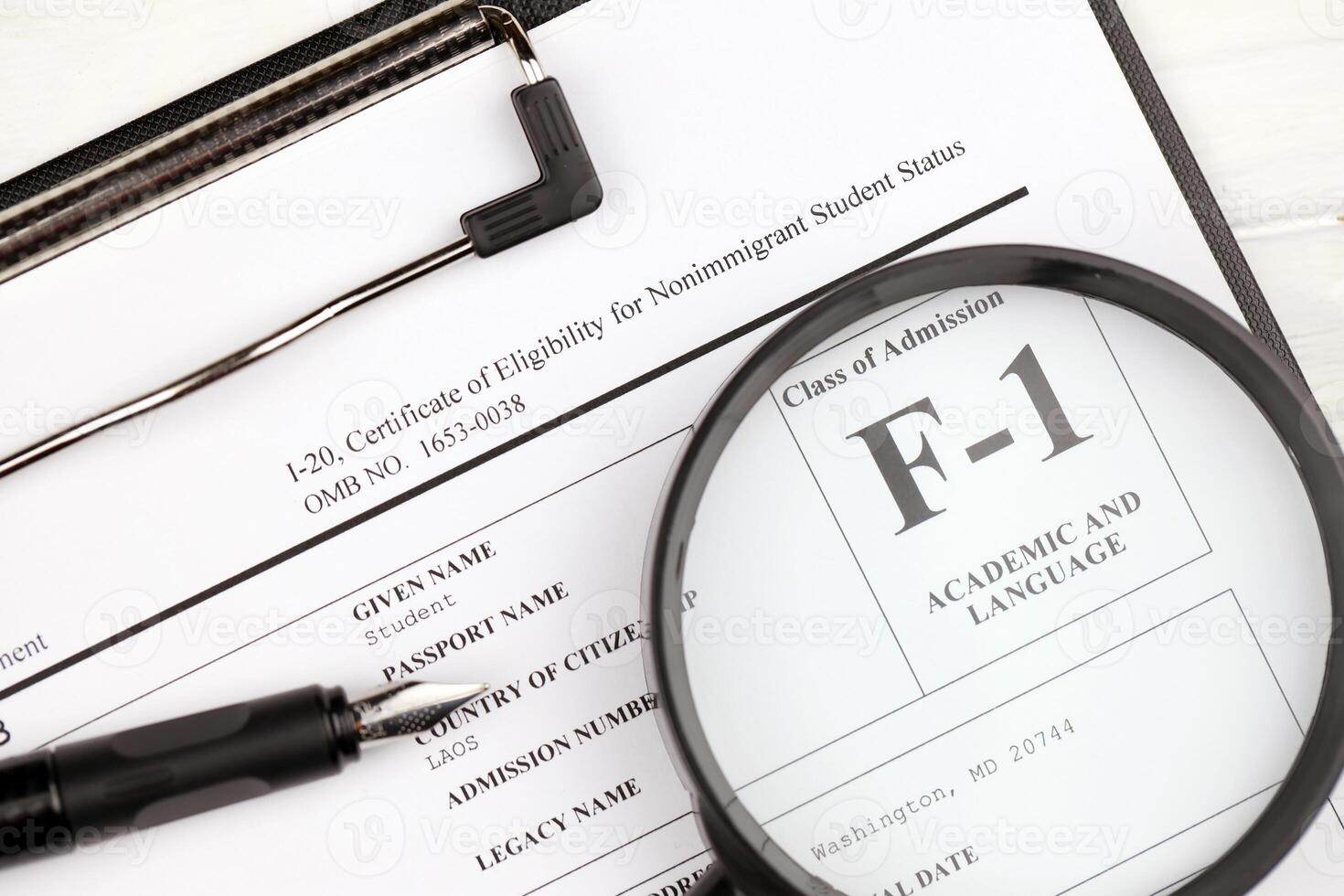 I-20 Certificate of eligibility for nonimmigrant student status blank form on A4 tablet lies on office table with pen and magnifying glass photo