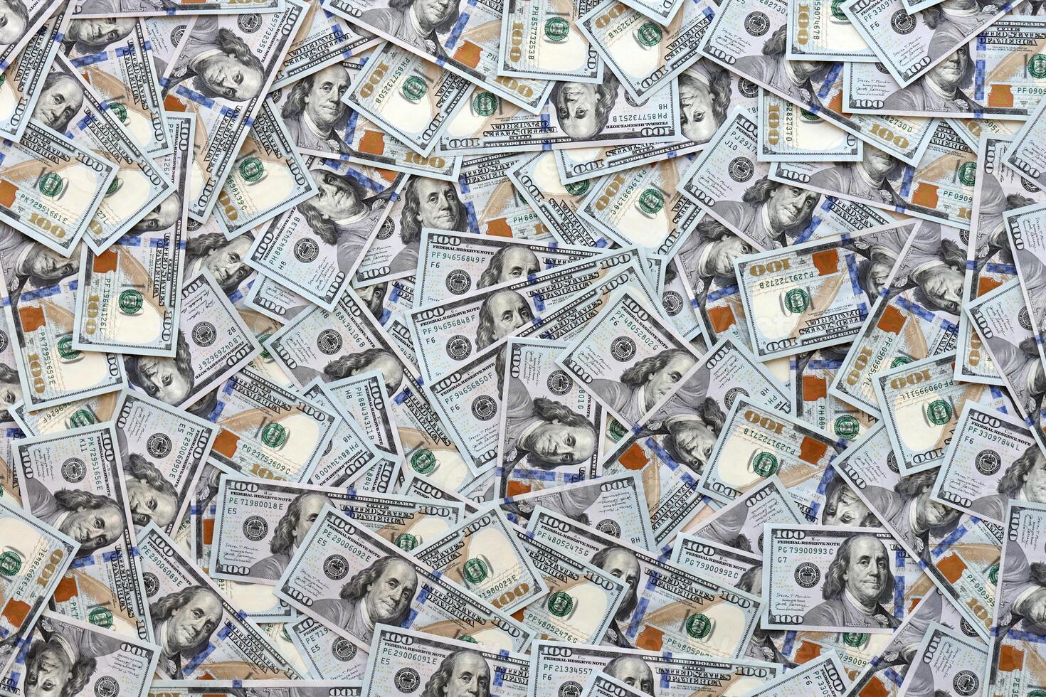 Very big amount of US hundred dollar bills. Huge quantity of united states currency notes on flat table photo