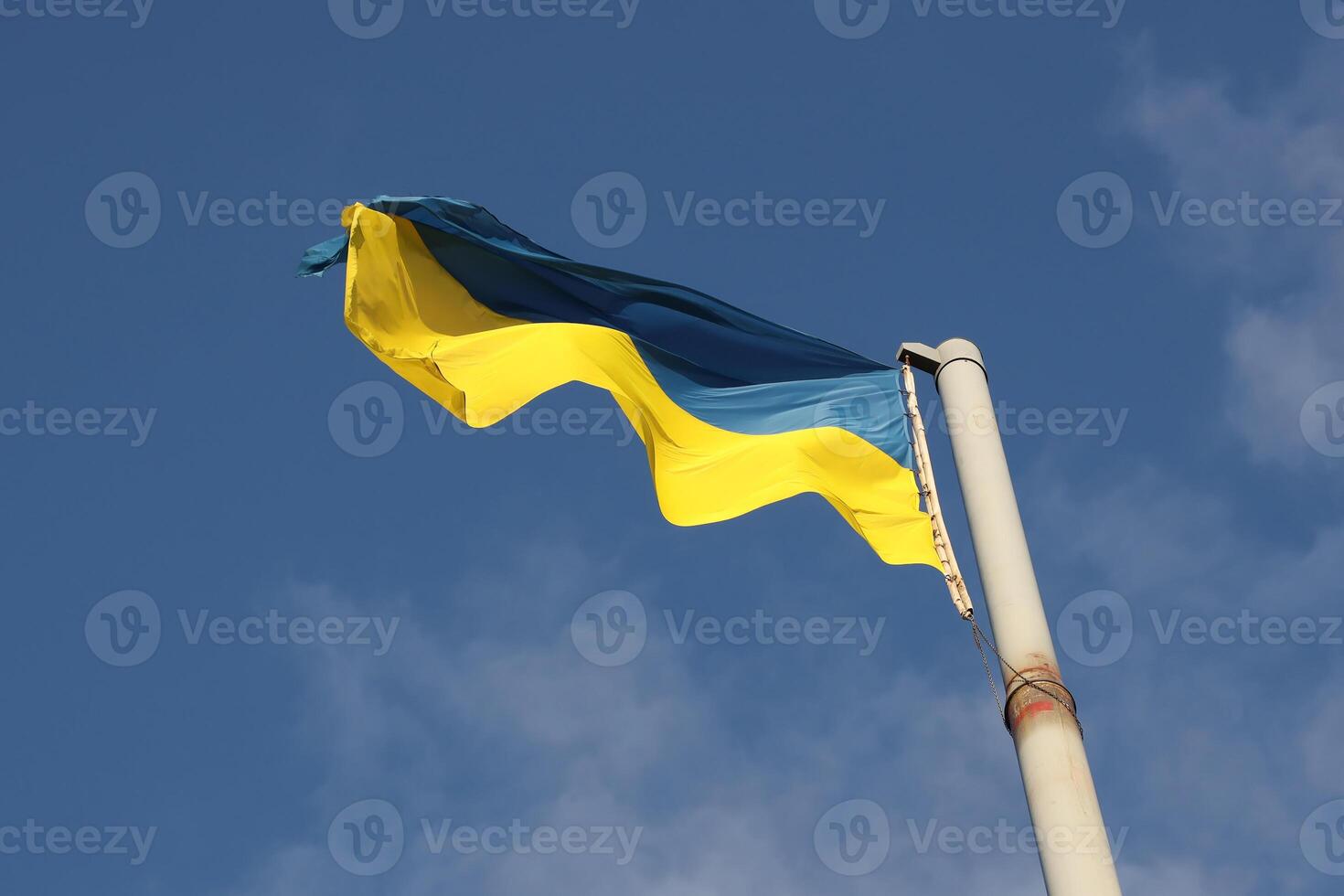 Ukraine flag large national symbol fluttering in blue sky. Large yellow blue Ukrainian state flag, Dnipro city, Independence Constitution Day photo