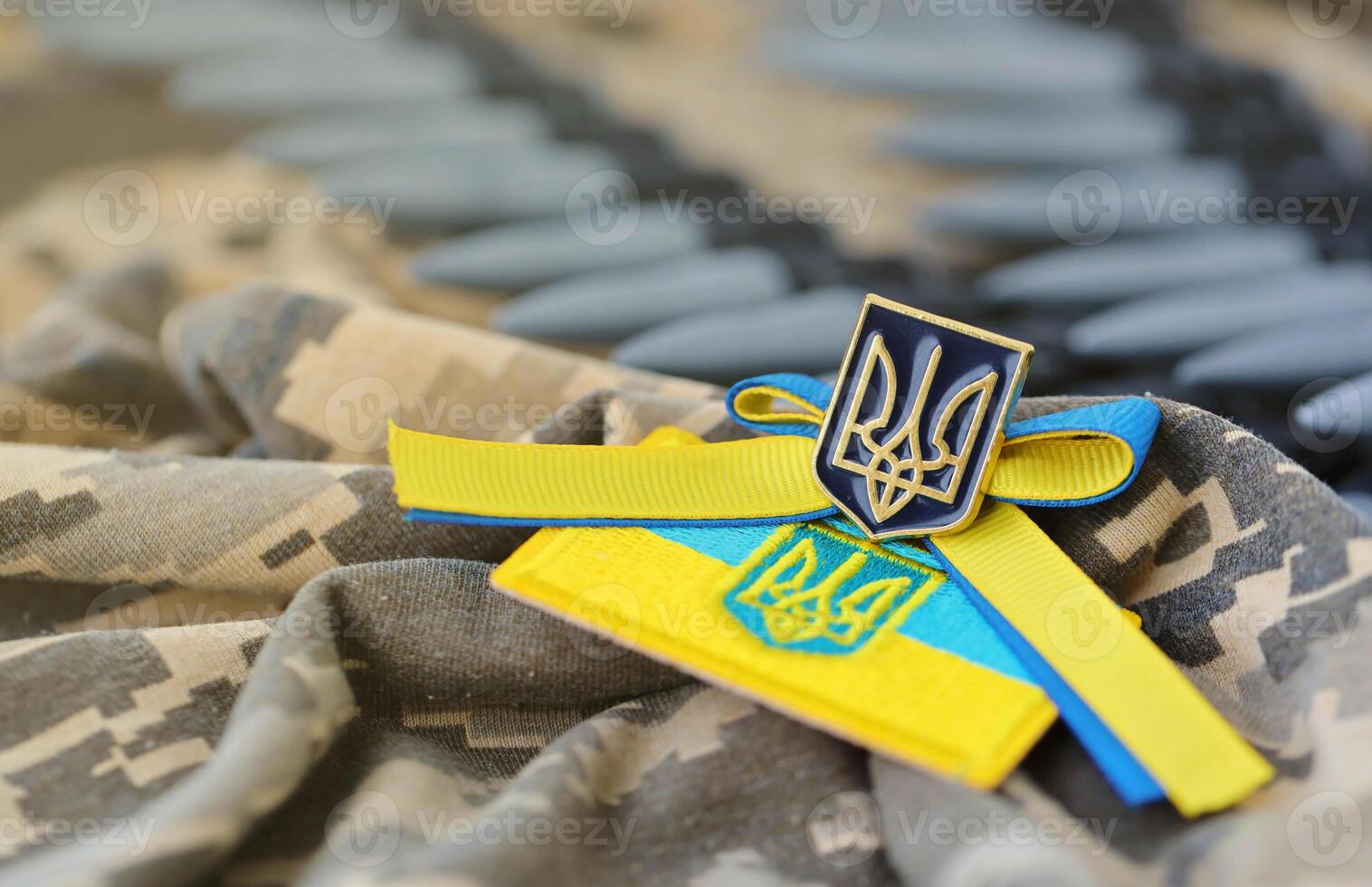 Ukrainian symbol and a machine gun belt on the camouflage uniform of a Ukrainian soldier. The Concept of war in Ukraine, patriotism and protecting your country from occupiers photo