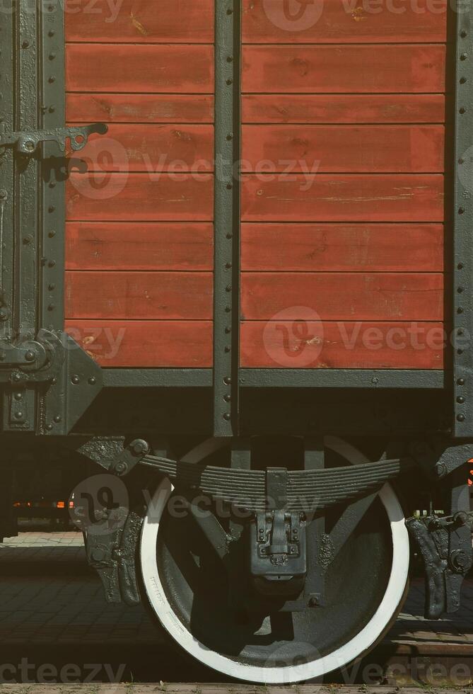 The side of the old brown wooden freight car with the wheel of the times of the Soviet Union photo