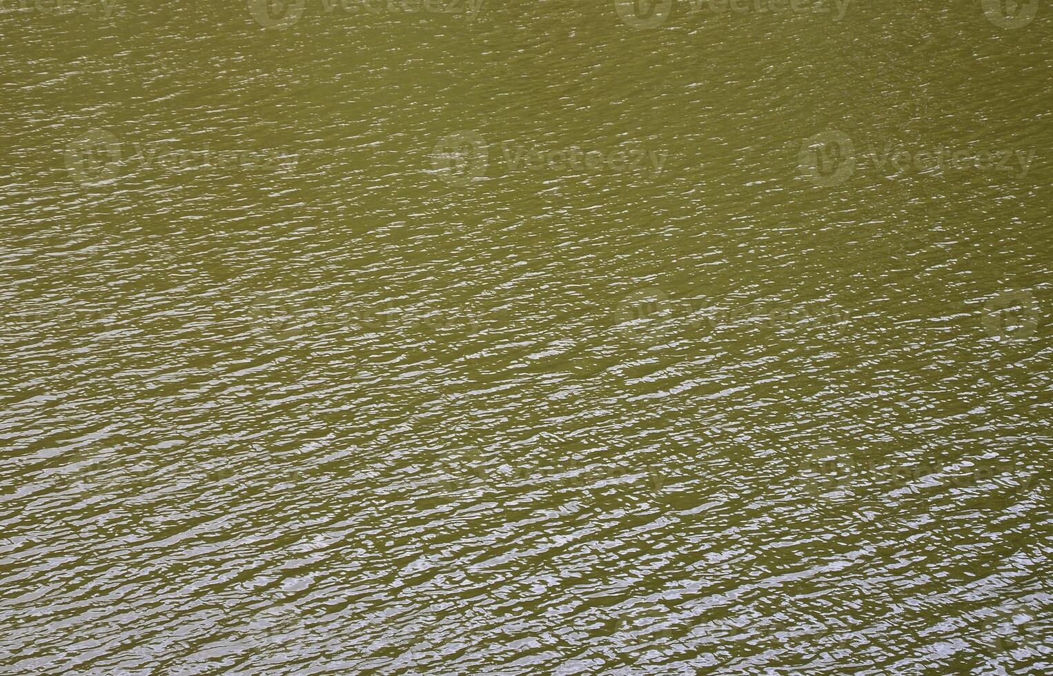 The texture of dark river water under the influence of wind, imprinted in perspective. Horizontal image photo