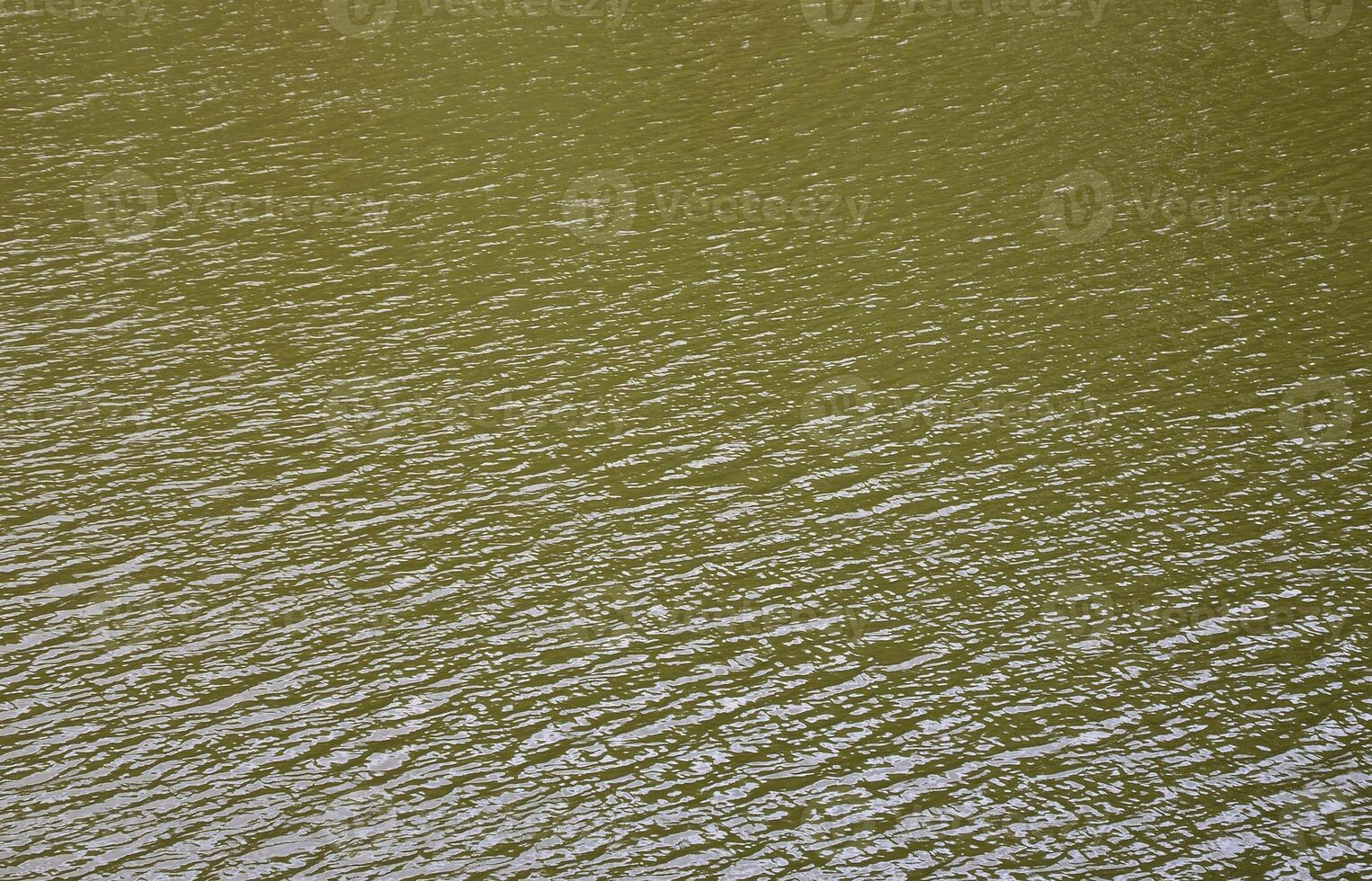 The texture of dark river water under the influence of wind, imprinted in perspective. Horizontal image photo