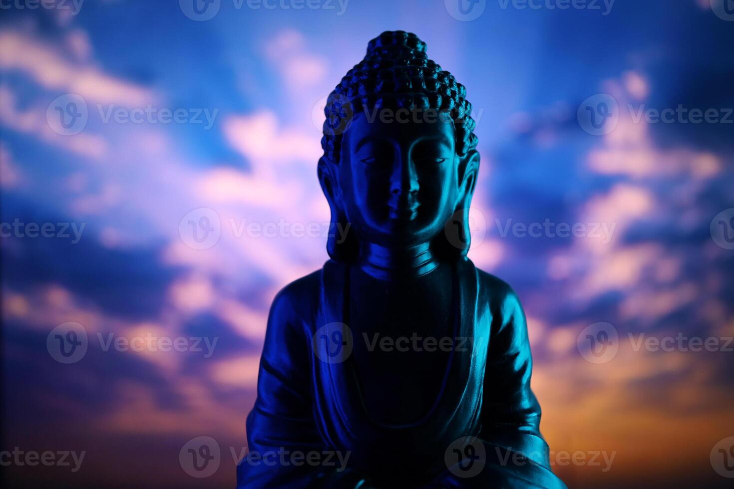 Buddha Purnima and Vesak day concept, Buddha statue with low key light against beautiful and colorful background. Meditation photo