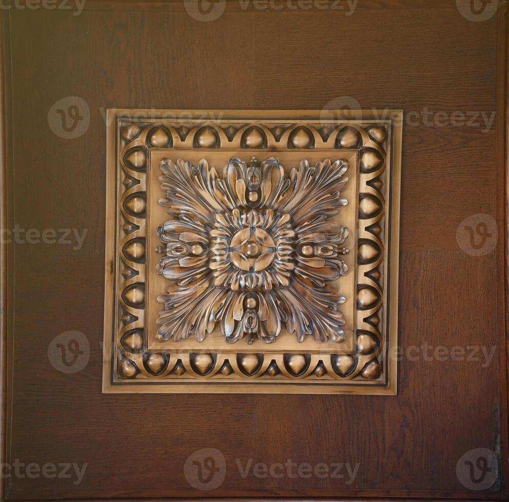Elegant dark brown ceiling with stone patterns and a rosette texture photo