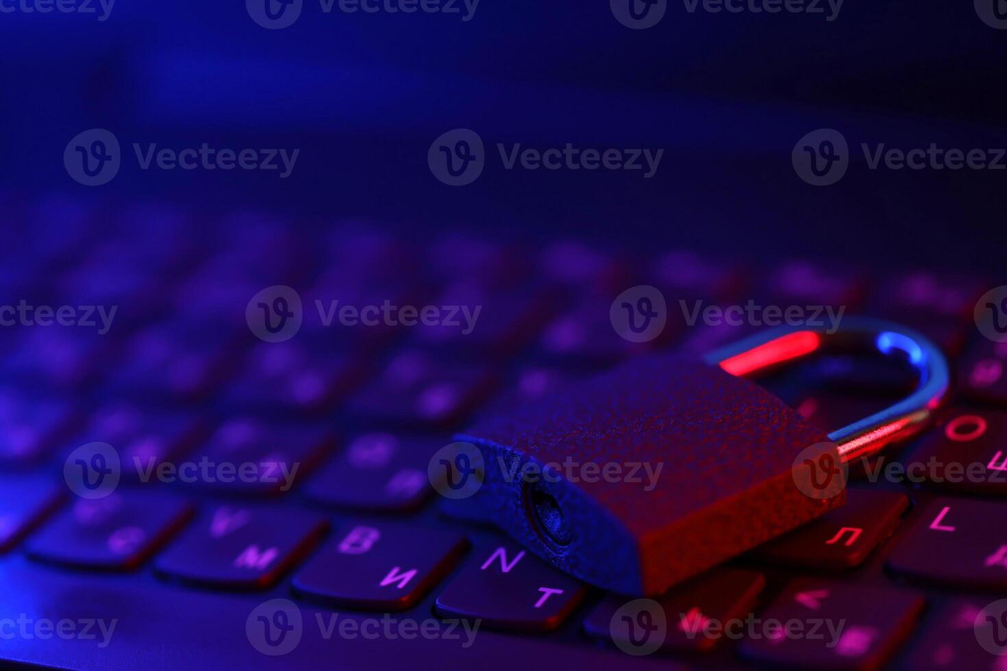 Computer security concept with a closed padlock on the keyboard. Padlock on top of a laptop keyboard. Selective focus photo