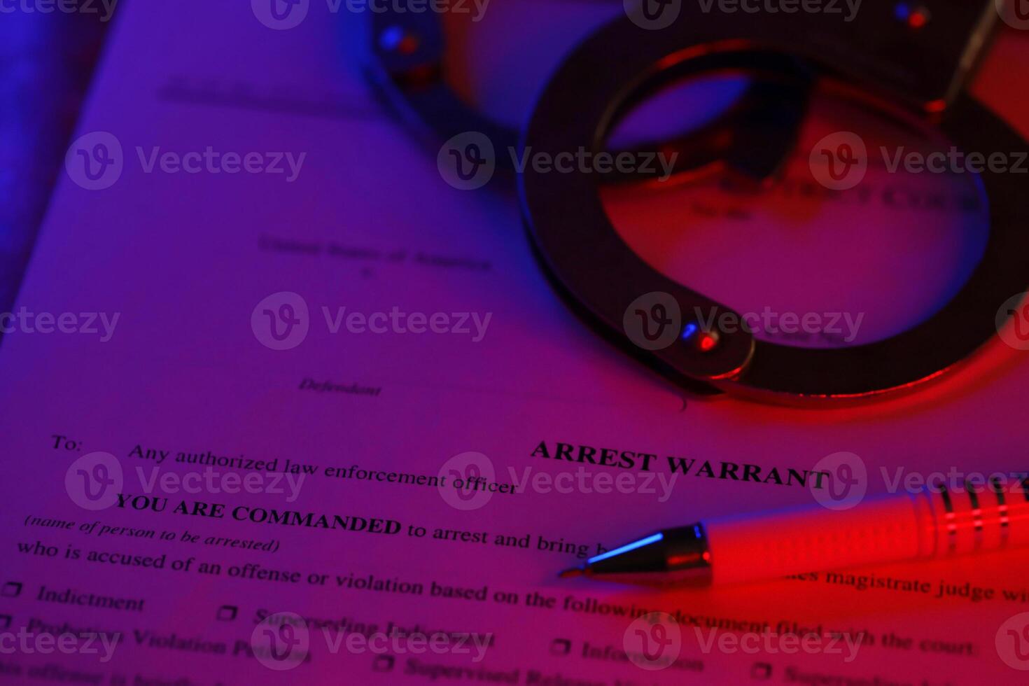 District Court Arrest Warrant court papers with handcuffs and blue pen on United States flag. Concept of permission to arrest photo