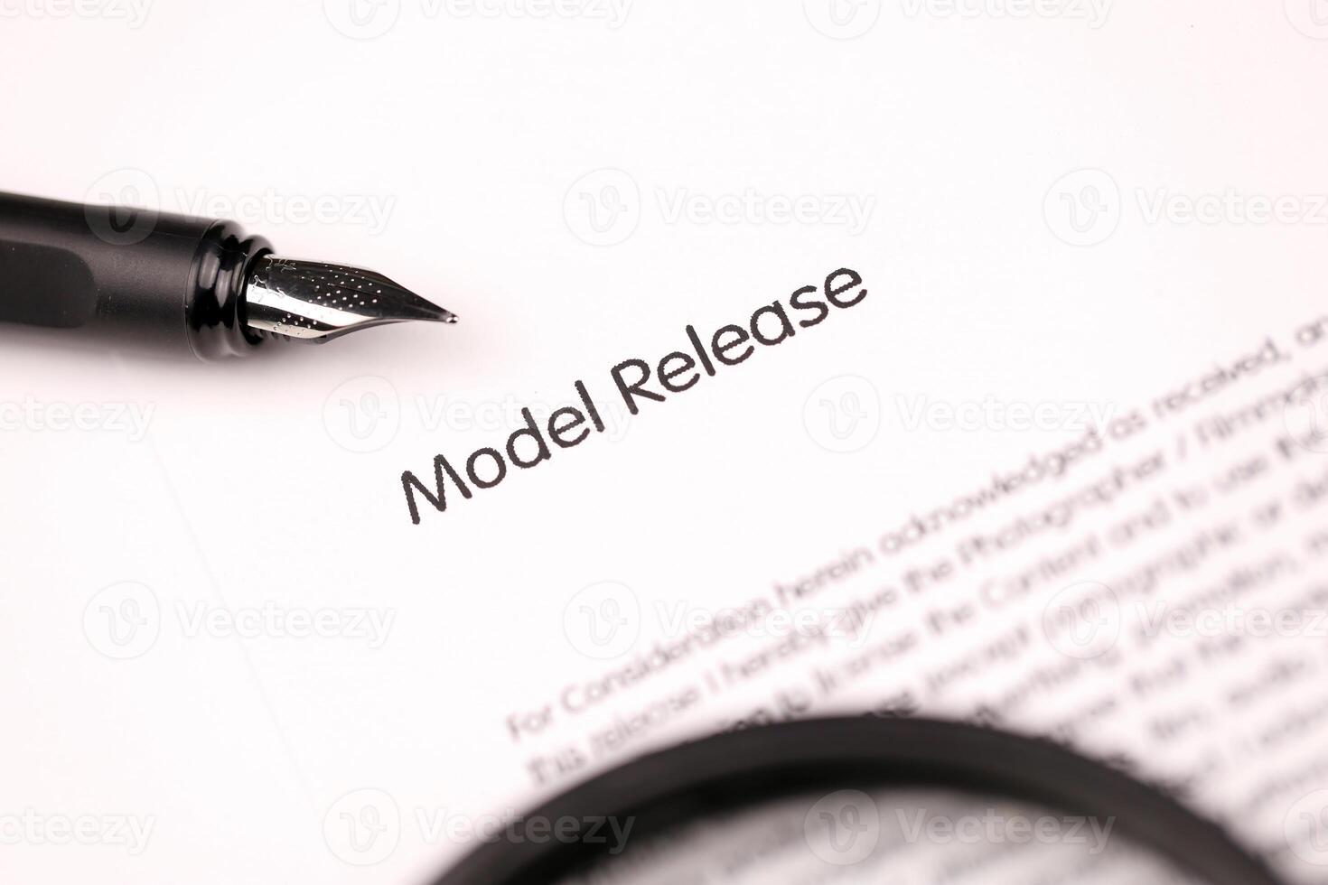 Model Release on A4 tablet lies on office table with pen and magnifying glass photo