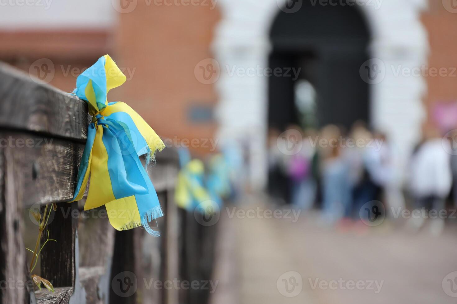 Ribbons in the colors of the national flag of Ukraine are tied to the handrail photo