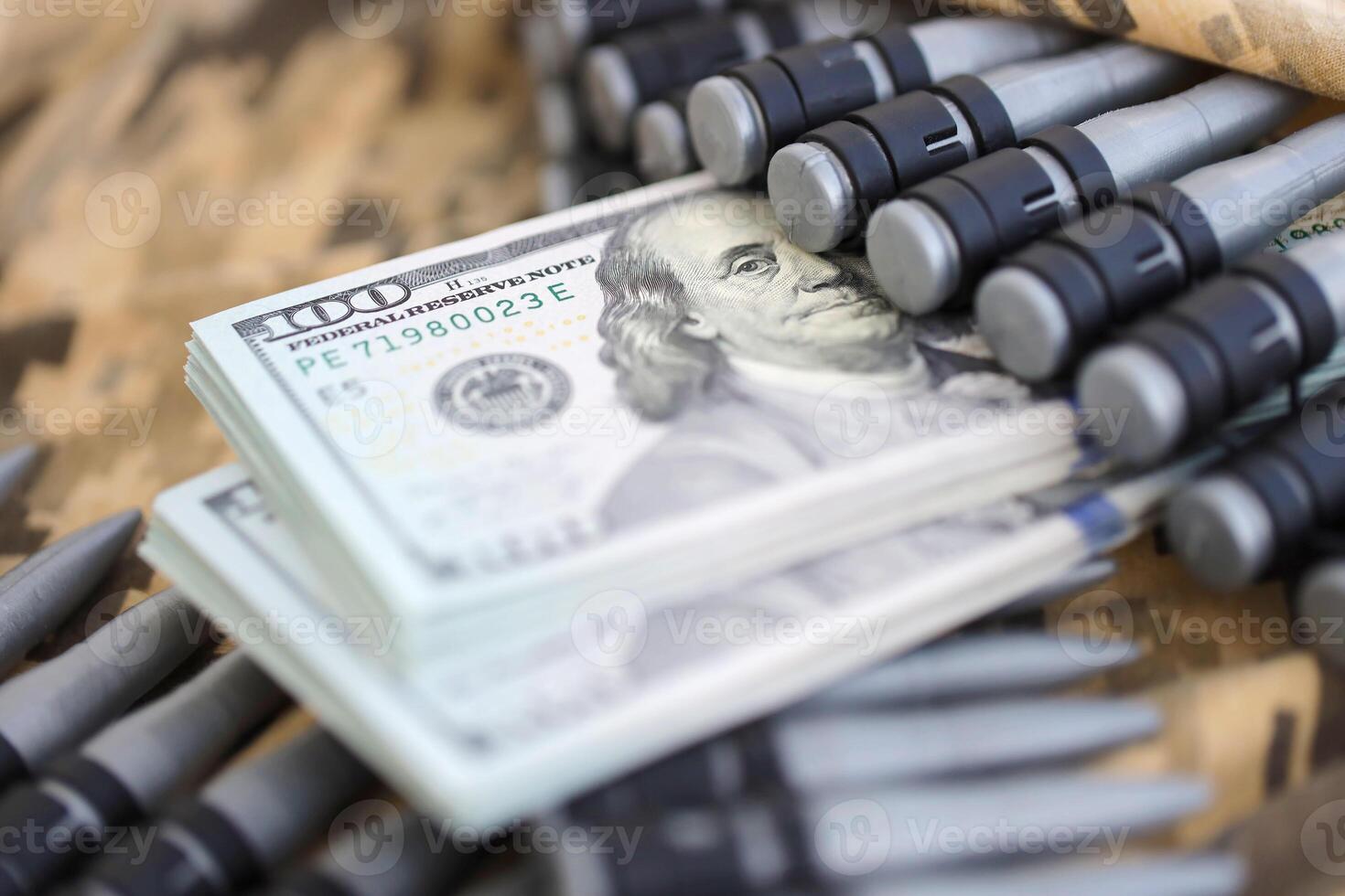 Bundles of dollars and a machine gun belt on the camouflage uniform of a Ukrainian soldier. Concept of war financing, bribe or donation photo