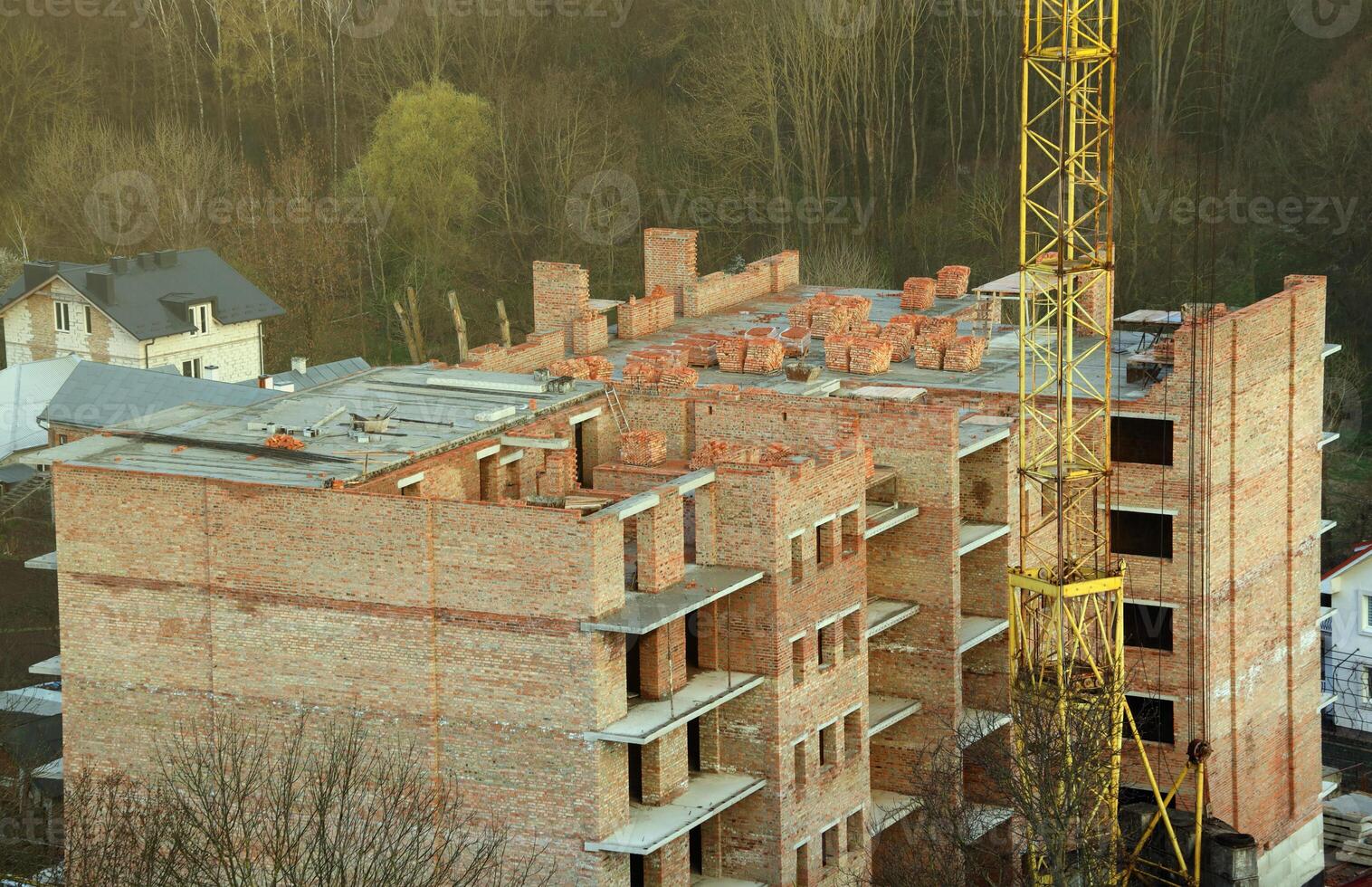View of a large construction site with buildings under construction and multi-storey residential homes. Housing renovation photo