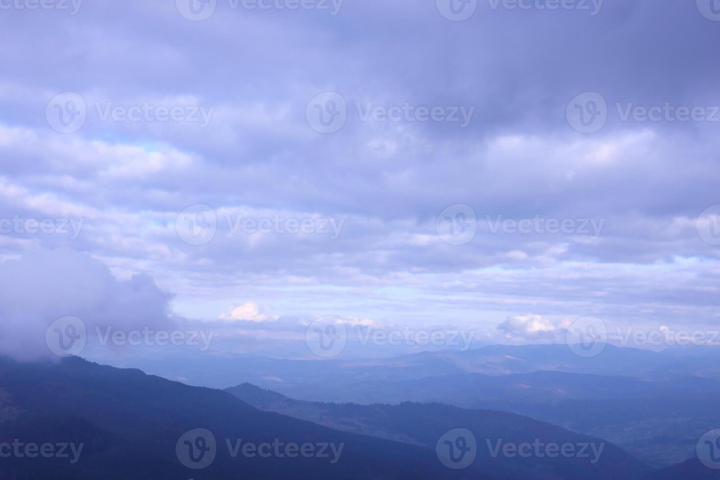 Morning view from the Dragobrat mountain peaks in Carpathian mountains, Ukraine. Cloudy and foggy landscape around Drahobrat Peaks photo