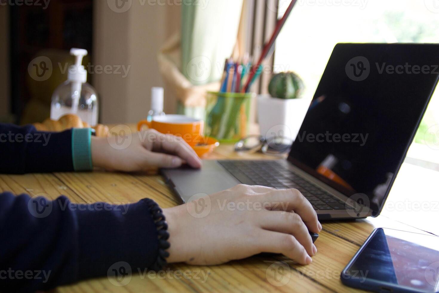 Women using laptop working and clean hands with alcohol drink coffee cup hot at home photo