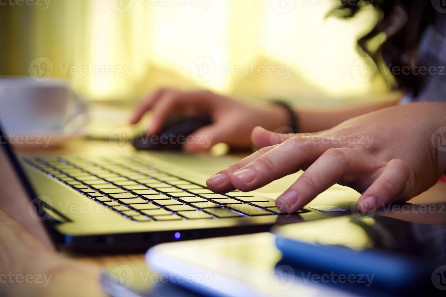 Women using laptop working and drink coffee cup hot at home photo