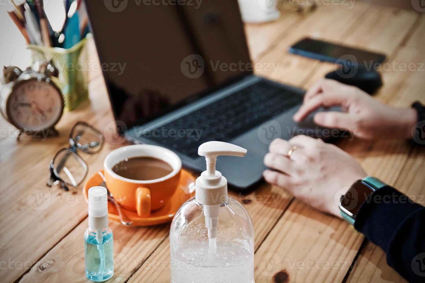Women using laptop working and clean hands with alcohol drink coffee cup hot at home photo