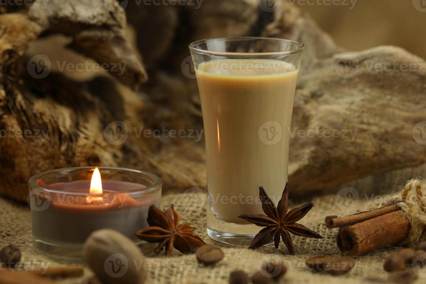 Glass of irish cream liqueur with spice. Cloth background with copy space photo