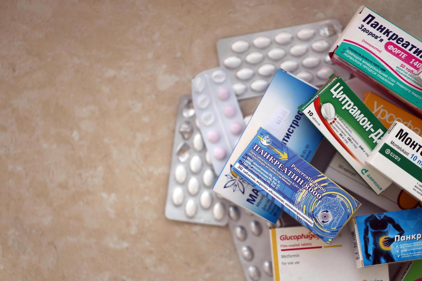 KYIV, UKRAINE - 4 MAY, 2023 Many boxes of pills and capsules stacked in pharmacy drug store photo