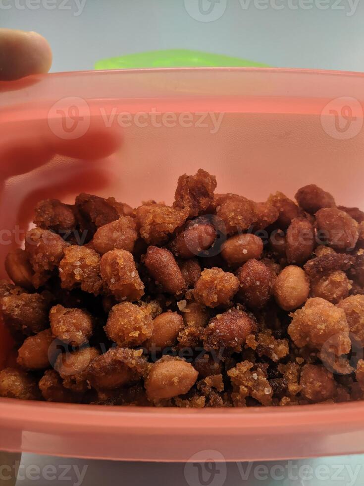 A view of the traditional cake of Ramadan or after the Eid al-Fitr holiday in Indonesia made from nuts as the main ingredient is seen in a bowl on a white background photo