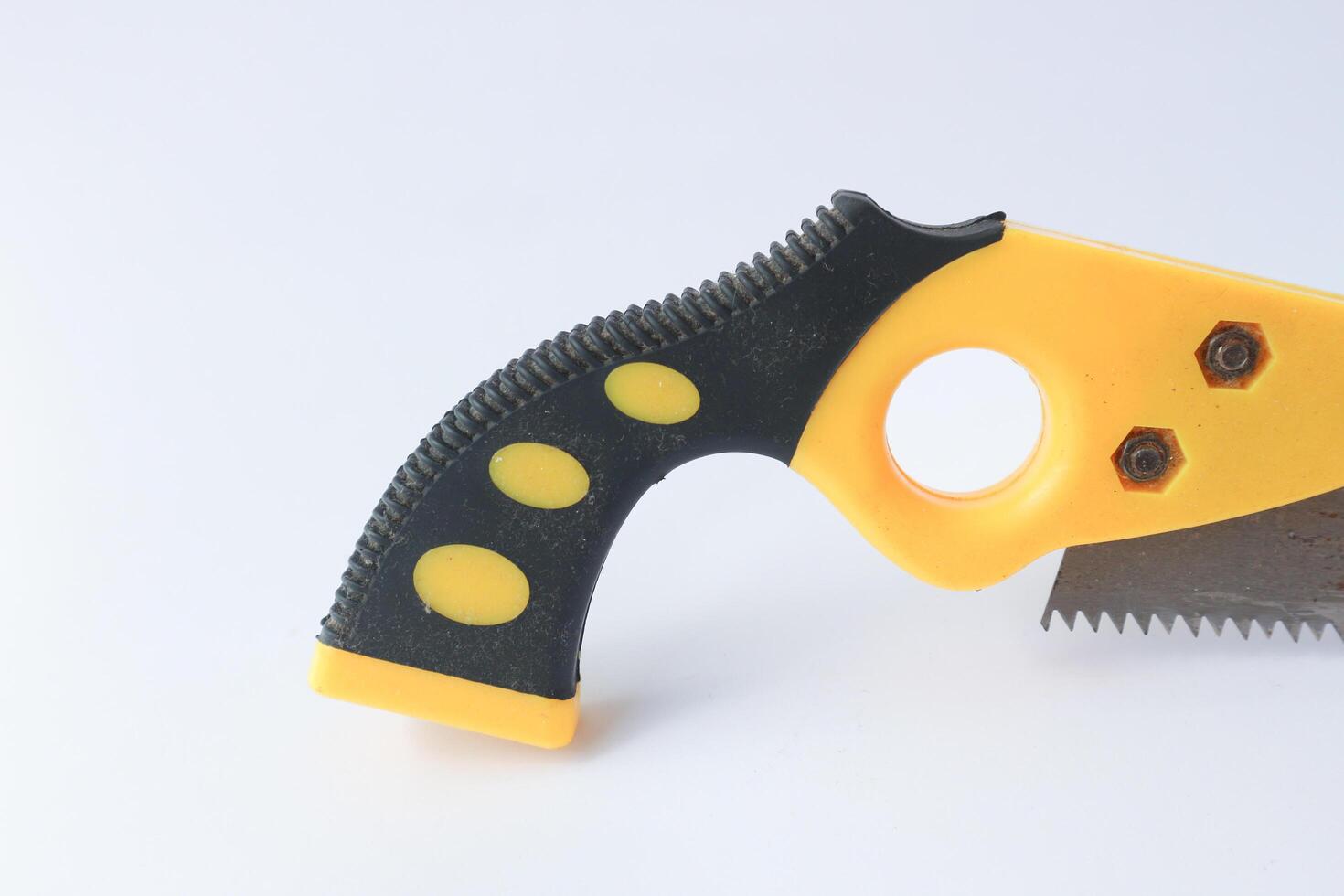 Hand saw with yellow plastic handle photo