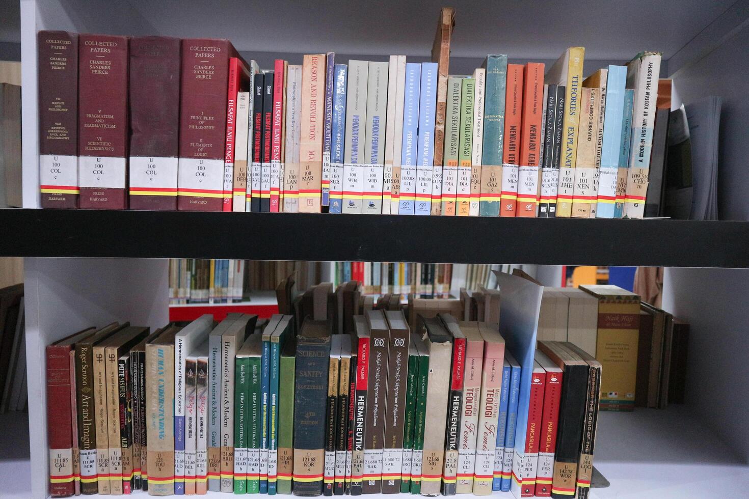 JAKARTA, INDONESIA - DECEMBER, 20 2023, a collection of books neatly arranged on a library shelf photo