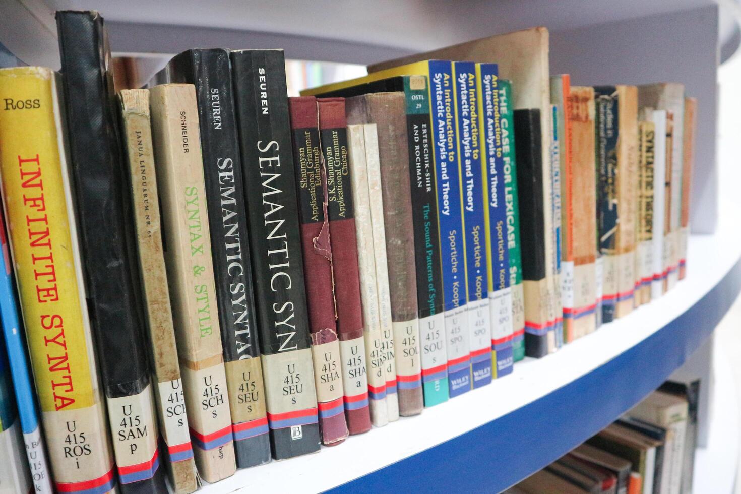 JAKARTA, INDONESIA - DECEMBER, 20 2023, a collection of books neatly arranged on a library shelf photo