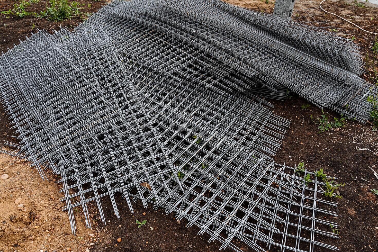 iron grid with square cells for the construction works, a metal grille folded in a pile photo
