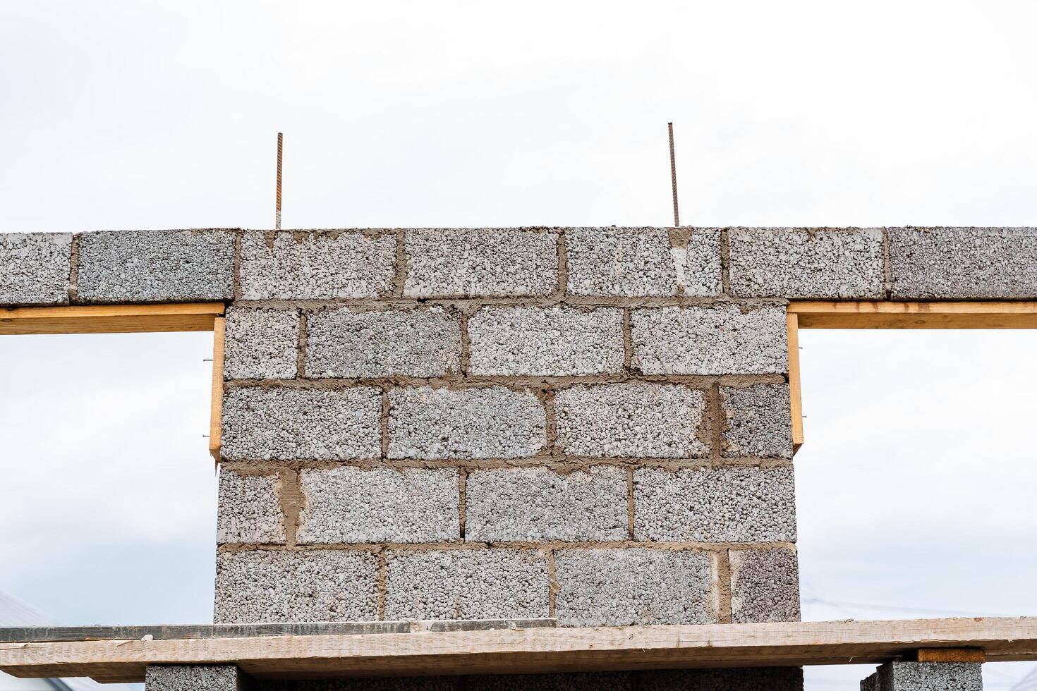 cinder blocks of gray concrete are neatly stacked in a pile, slender rows of bricks, material for building a house photo