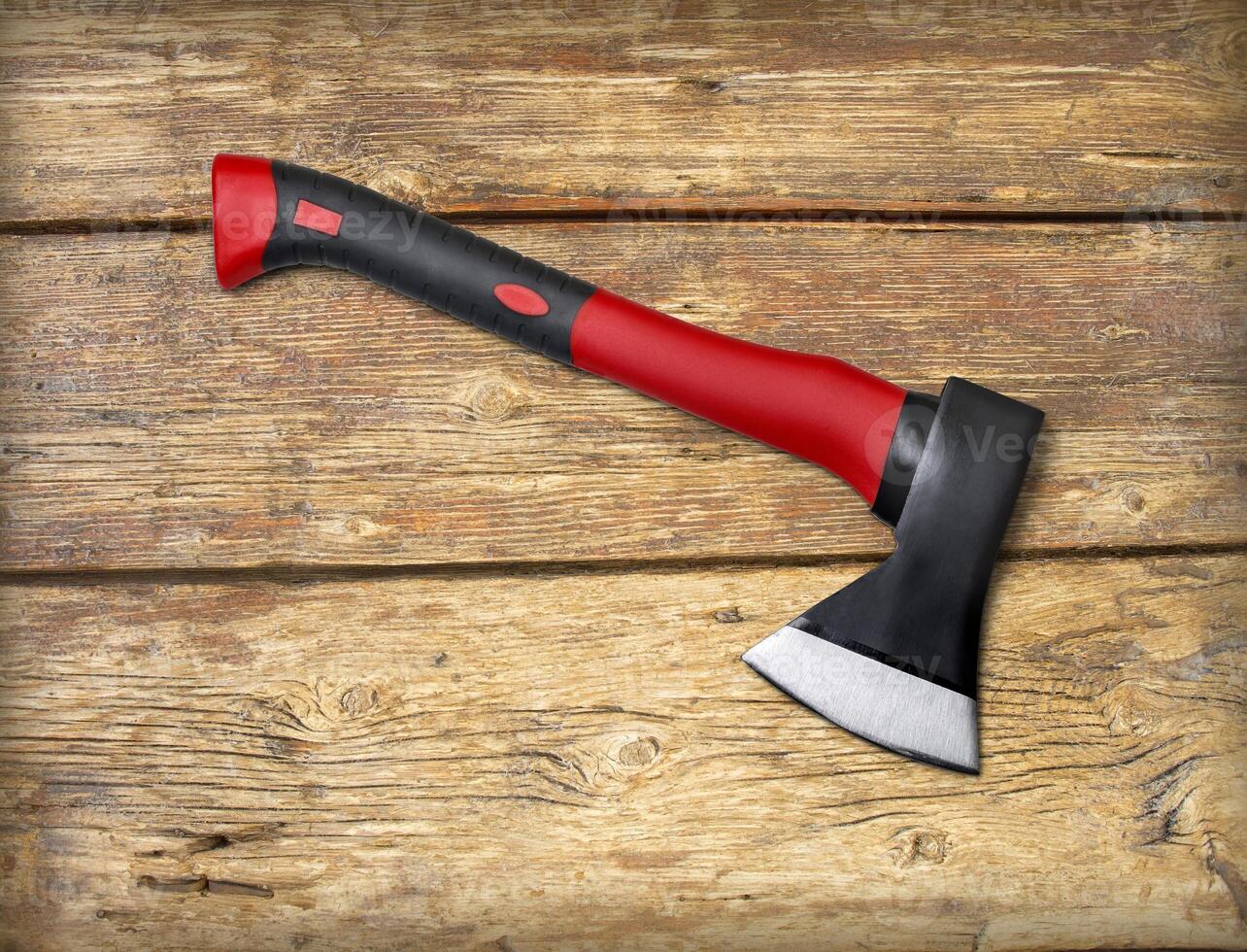 Red ax on a wooden photo