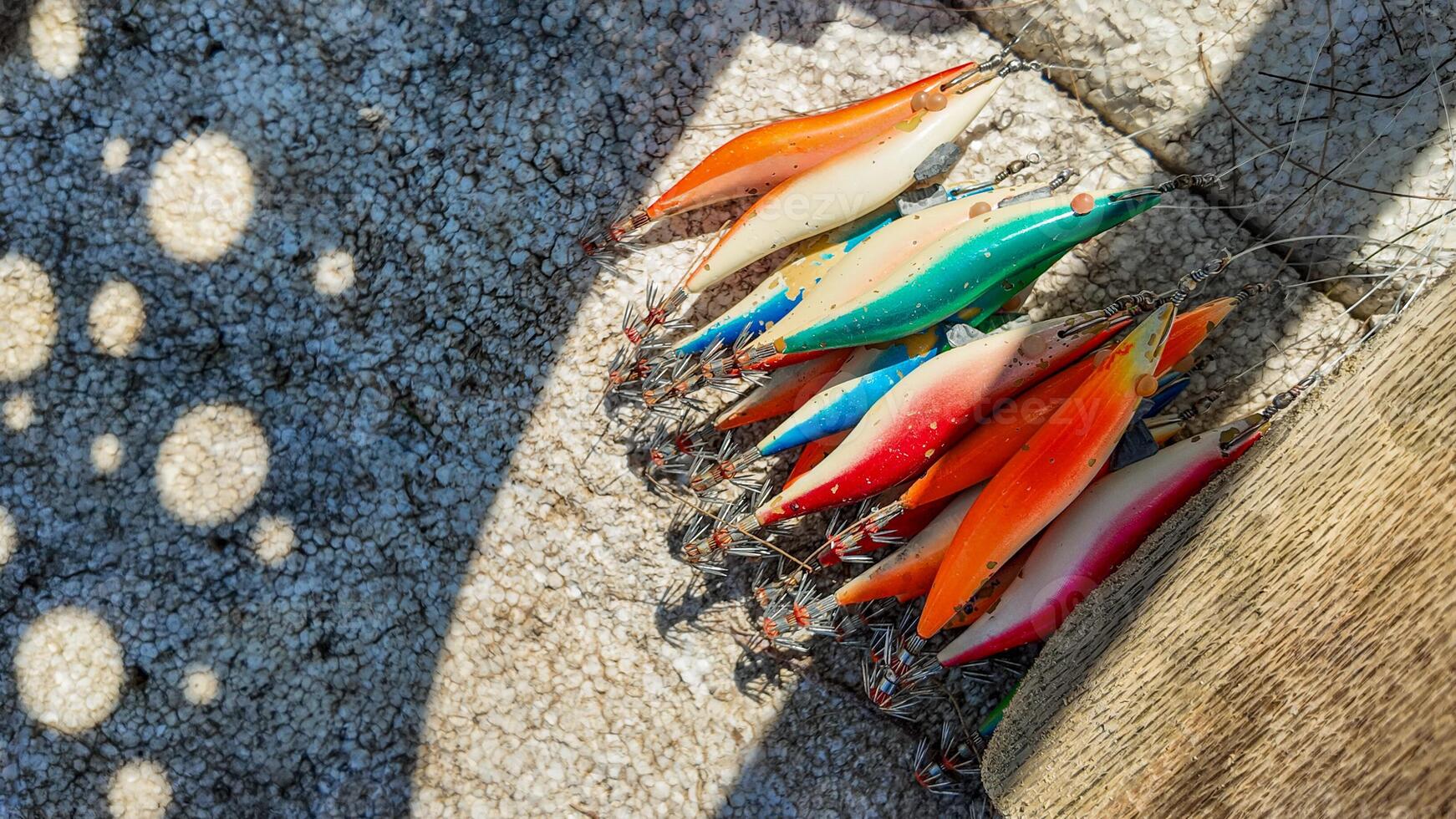 Colorful Fishing Lures Casting Sunlit Shadows photo
