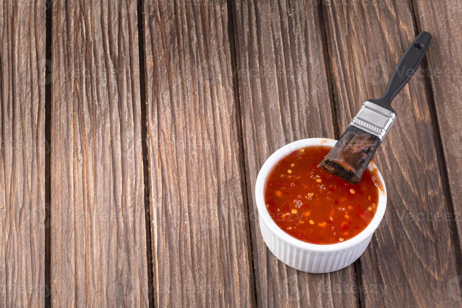 Barbecue sauce with basting brush photo