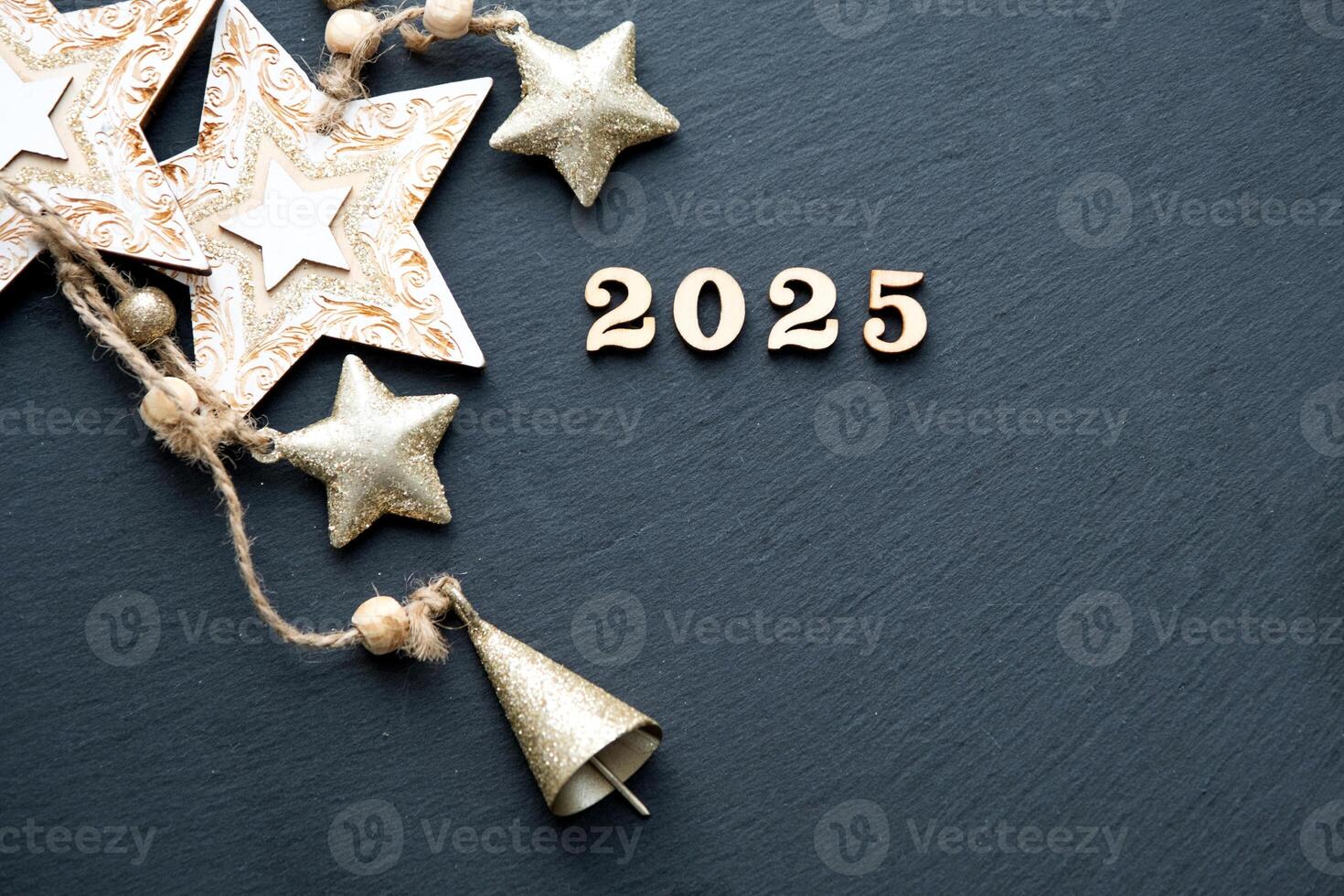 Happy New Year-wooden letters and the numbers 2025 on festive black background with sequins, stars, snow. Greetings, postcard. Calendar, cover photo