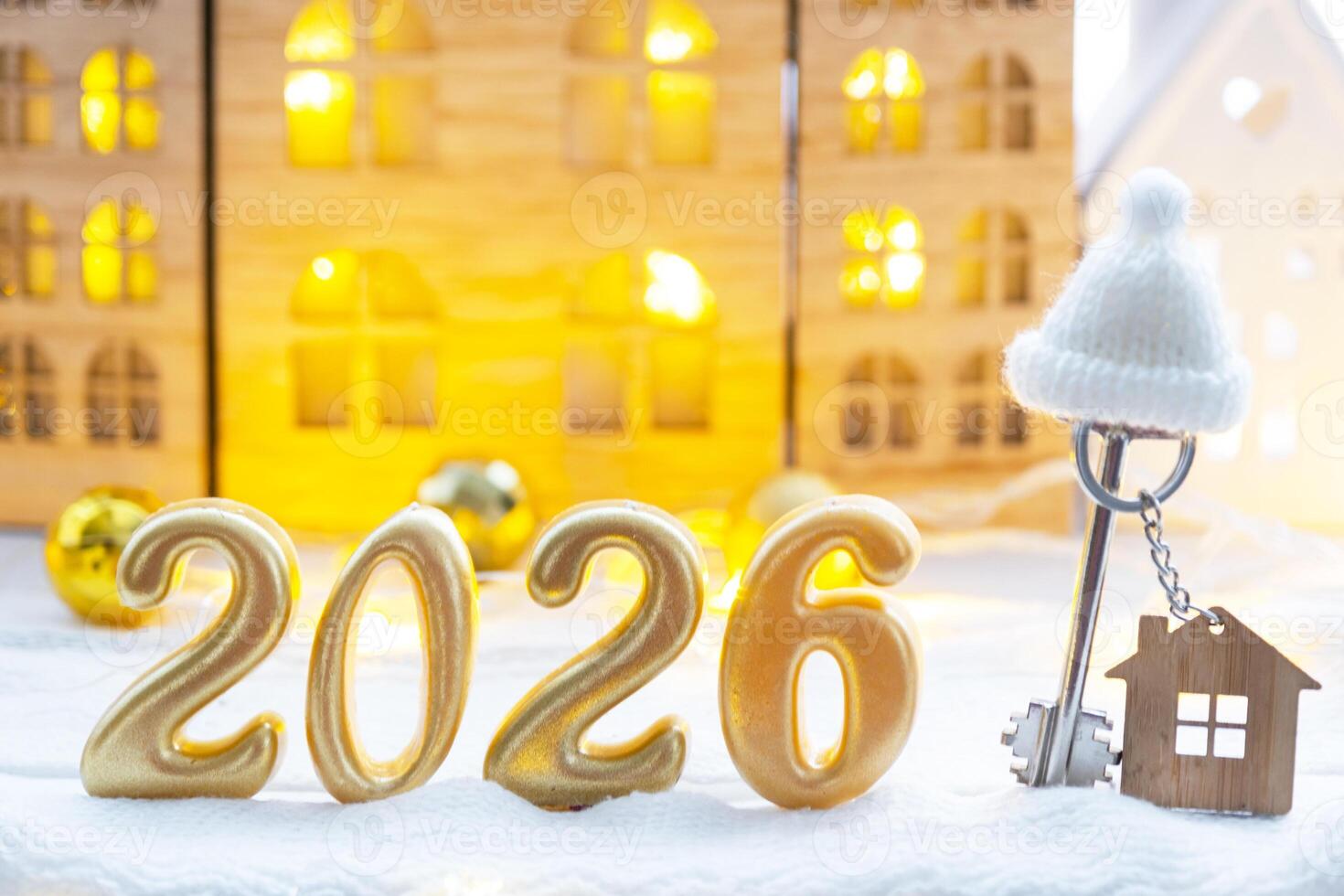 Golden figures number 2026, key and tiny home on background of cozy windows of a house with warm light with festive decor of stars,snow and garlands. Greeting card, Happy New Year, cozy home photo