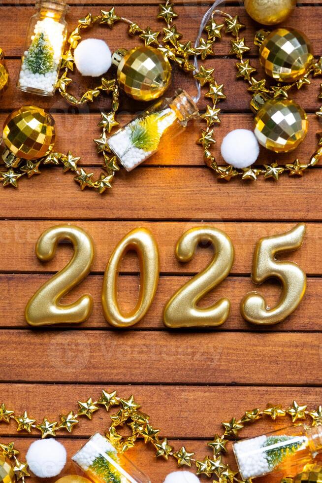 Happy New Year wooden numbers 2025 on cozy festive brown wooden background with sequins, snow, lights of garlands. Greetings, postcard. Calendar, cover photo