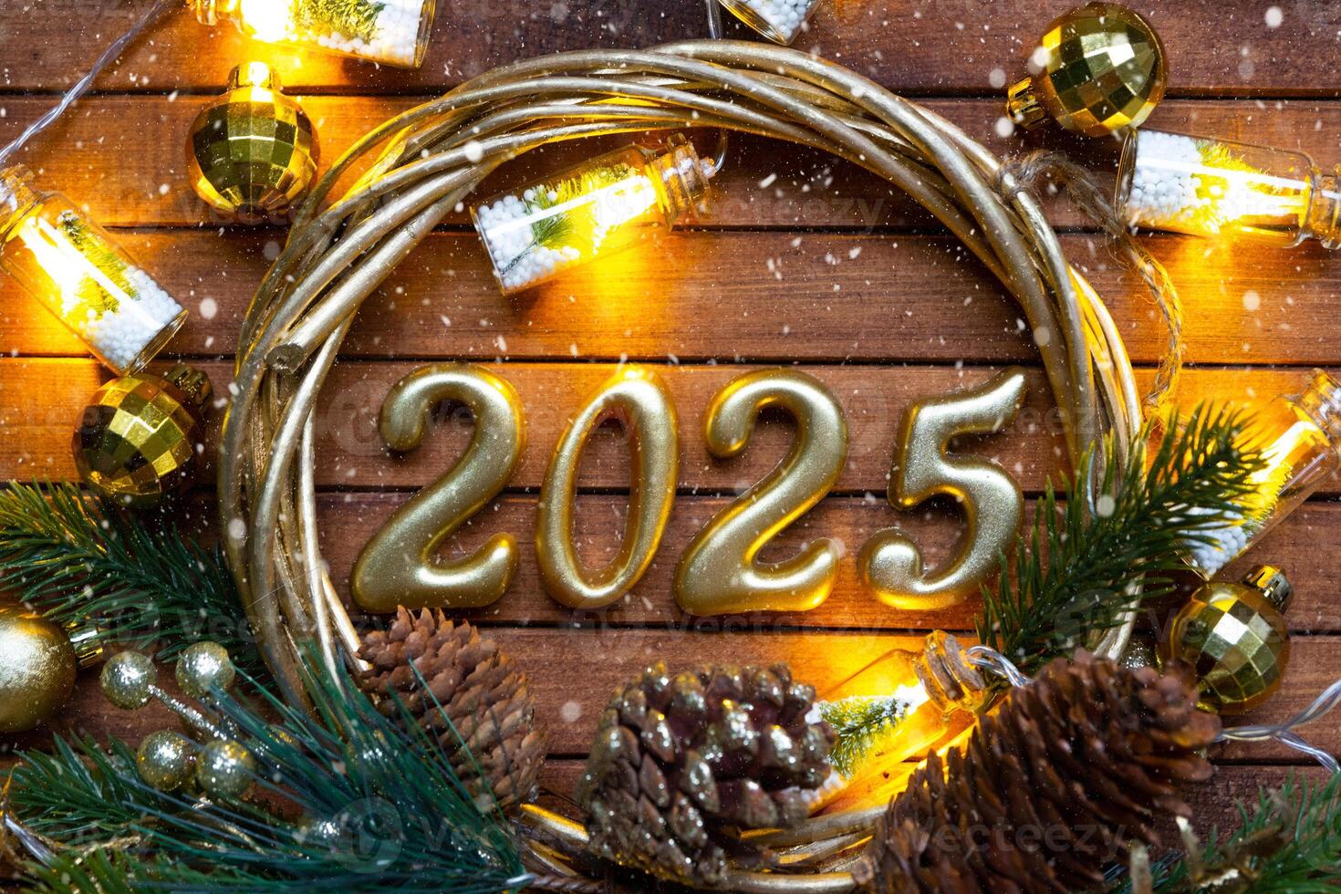 Happy New Year golden numbers 2025 on cozy festive brown wooden background with sequins, snow, lights of garlands. Greetings, postcard. Calendar, cover photo