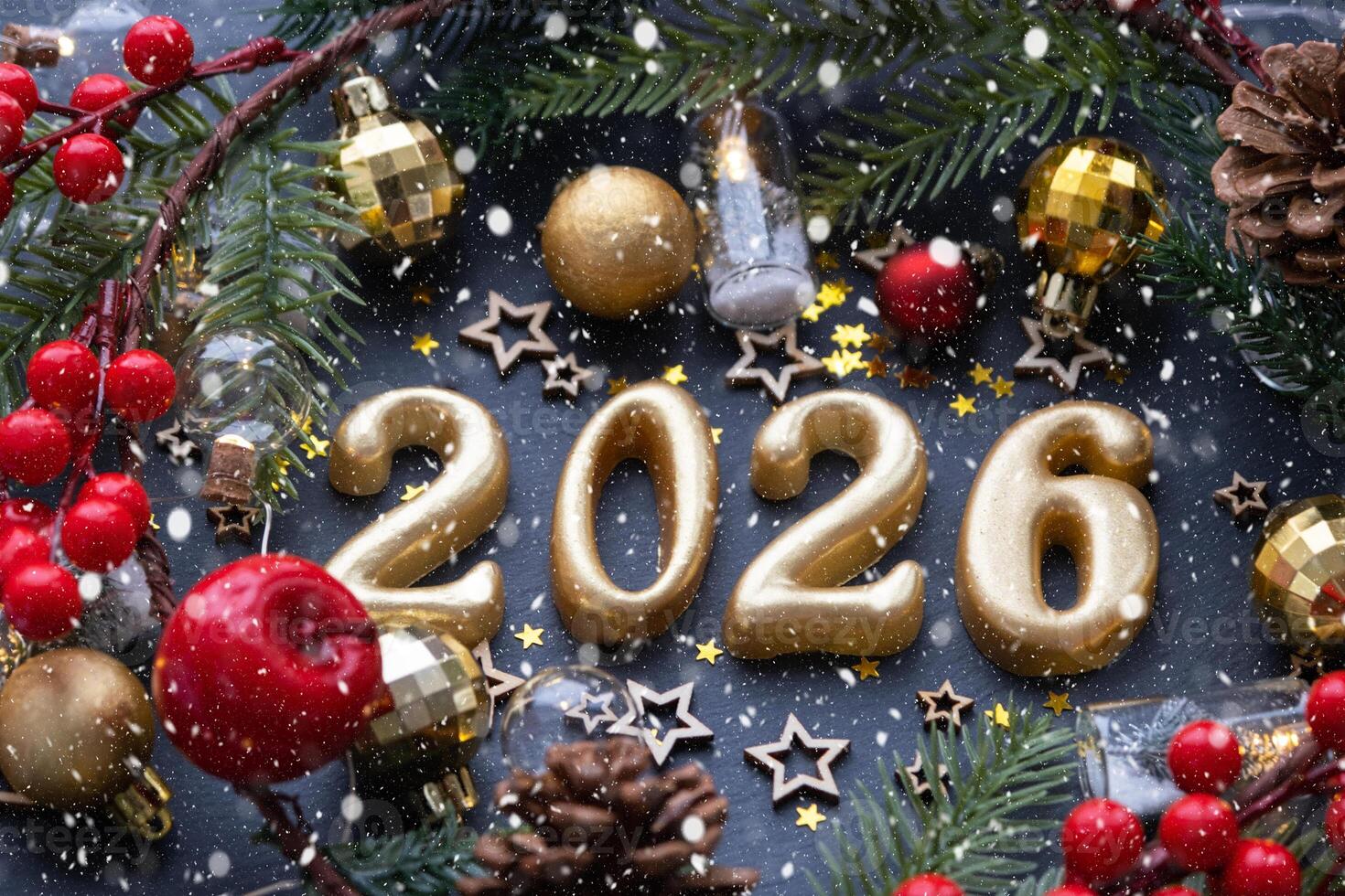 The golden figures 2026 made of candles on a black stone slate background are decorated with a festive decor of stars, sequins, fir branches, balls and garlands. Greeting card, happy New Year. photo