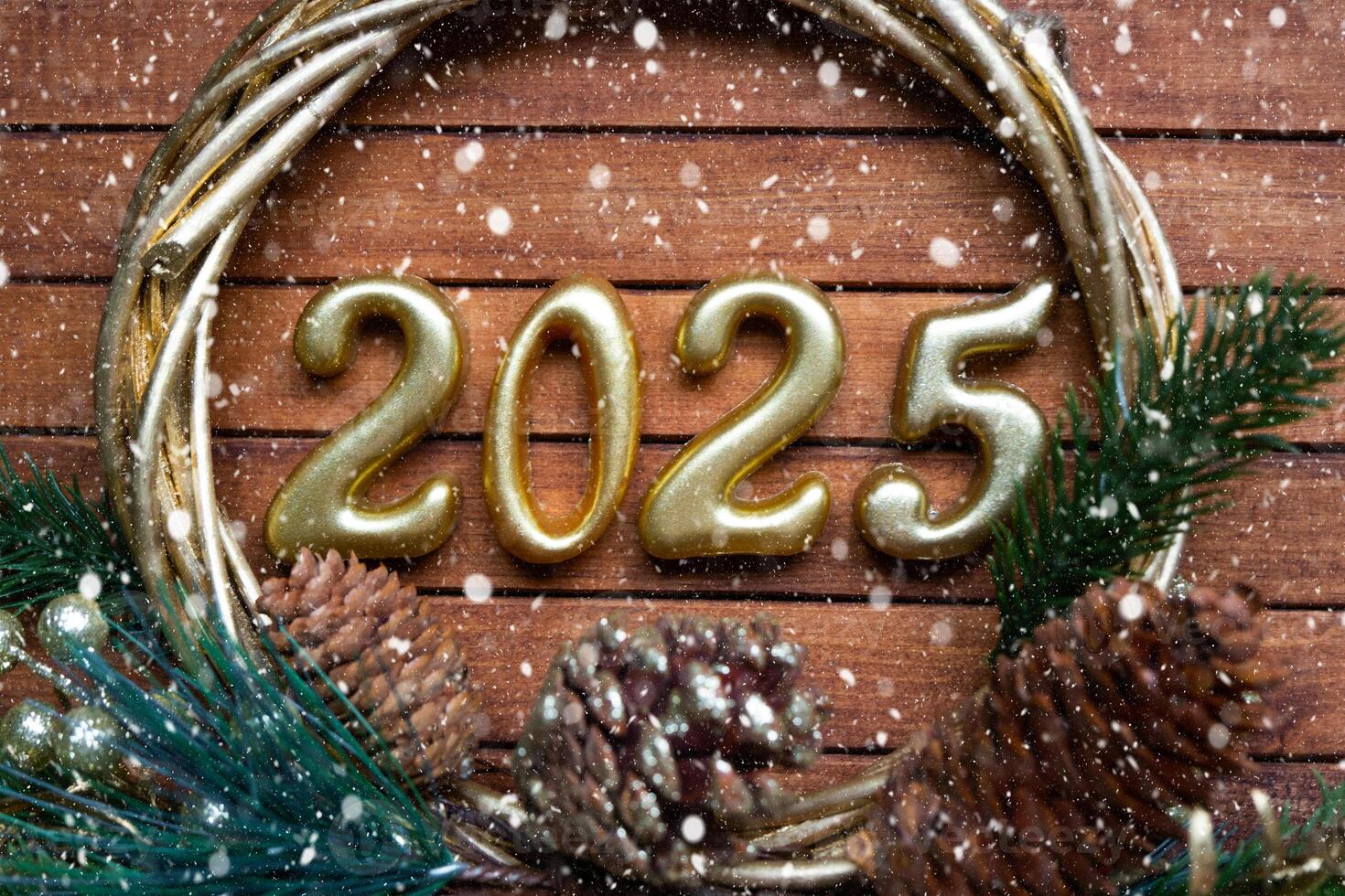 Happy New Year golden numbers 2025 on cozy festive brown wooden background with sequins, snow, lights of garlands. Greetings, postcard. Calendar, cover photo