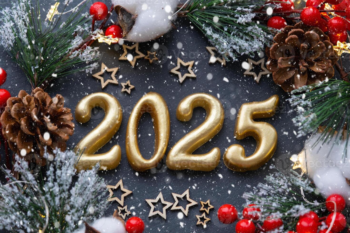 The golden figures 2025 made of candles on a black stone slate background are decorated with a festive decor of stars, sequins, fir branches, balls and garlands. Greeting card, happy New Year. photo