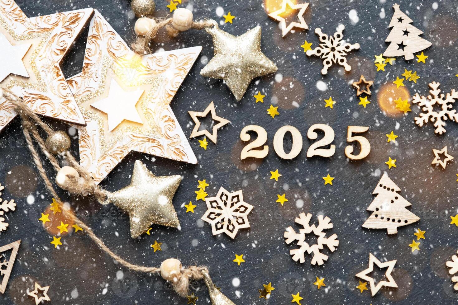 Happy New Year-wooden letters and the numbers 2025 on festive black background with sequins, stars, snow. Greetings, postcard. Calendar, cover photo