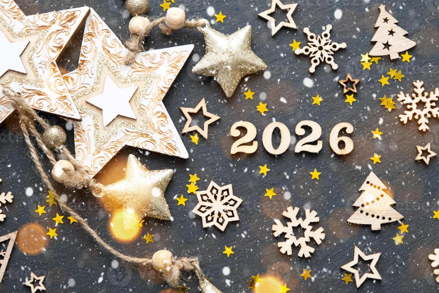 Happy New Yearwooden letters and the numbers 2026 on festive black