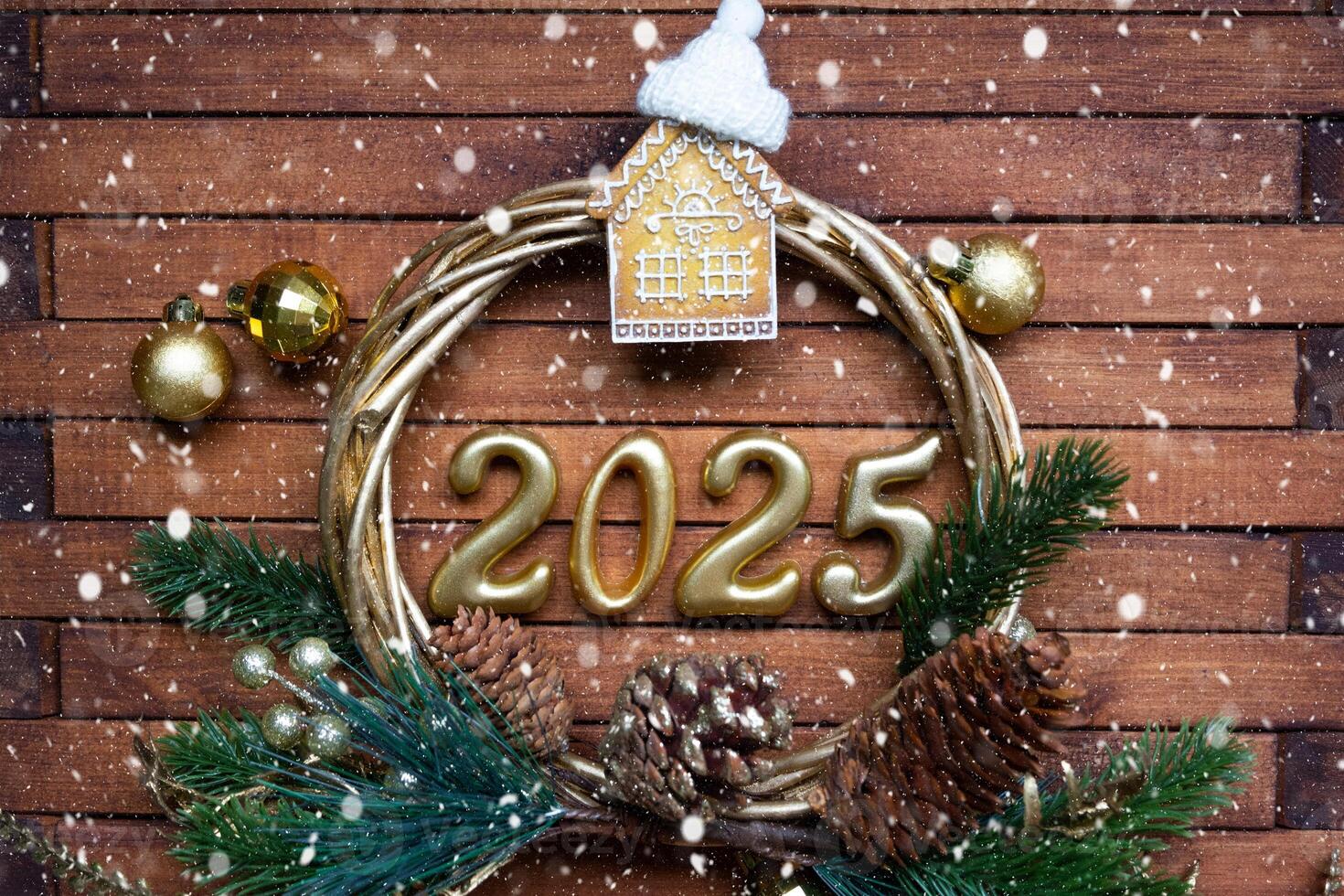 New Year House key with keychain cottage on festive brown wooden background with number 2025 in wreath, lights of garlands. Purchase, construction, relocation, mortgage, insurance photo