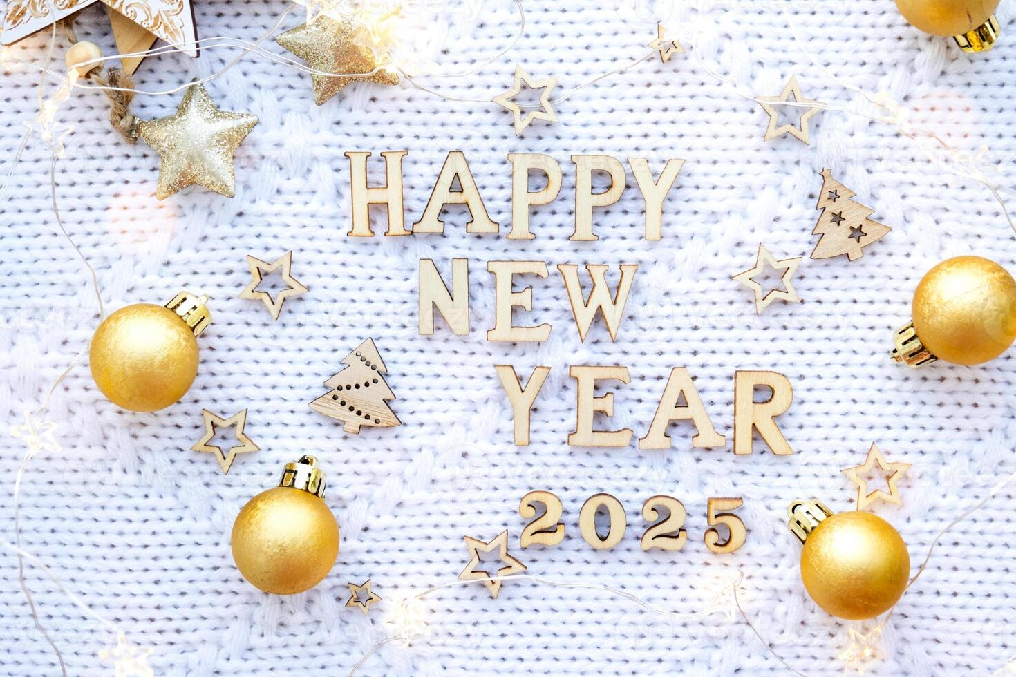 Happy New Year wooden numbers 2025 on cozy festive white knitted background with sequins, stars, lights of garlands. Greetings, postcard. Calendar, cover photo