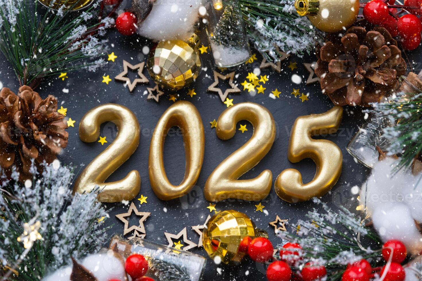 The golden figures 2025 made of candles on a black stone slate background are decorated with a festive decor of stars, sequins, fir branches, balls and garlands. Greeting card, happy New Year. photo