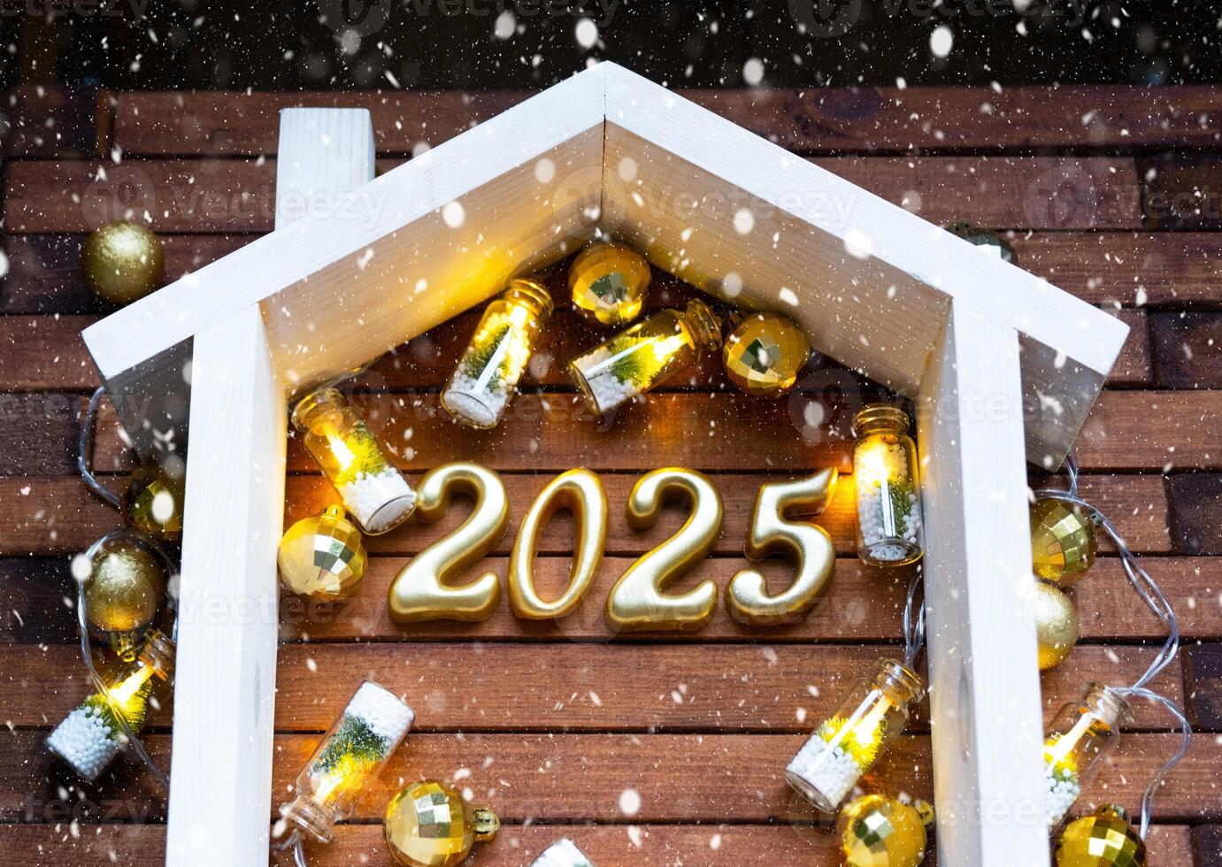 New Year 2025 golden letters under roof house. Calendar, greeting card. Purchase, construction, relocation, mortgage, insurance photo